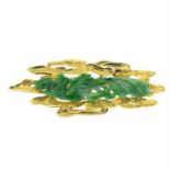 A carved jade dragon brooch.