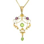 An Edwardian 9ct gold garnet and peridot openwork pendant, with 9ct gold trace-link chain.