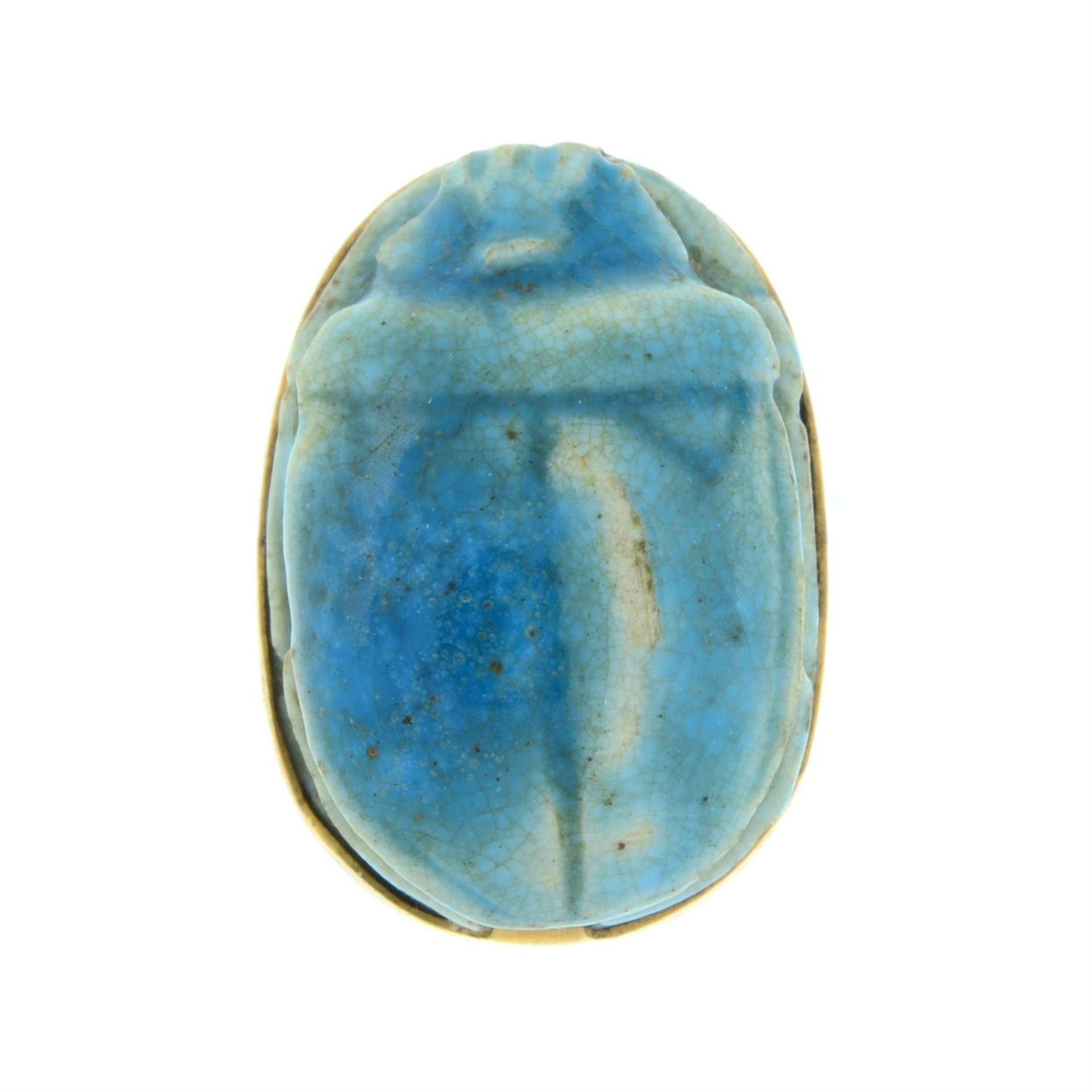 A porcelain scrub beetle slider pendant.