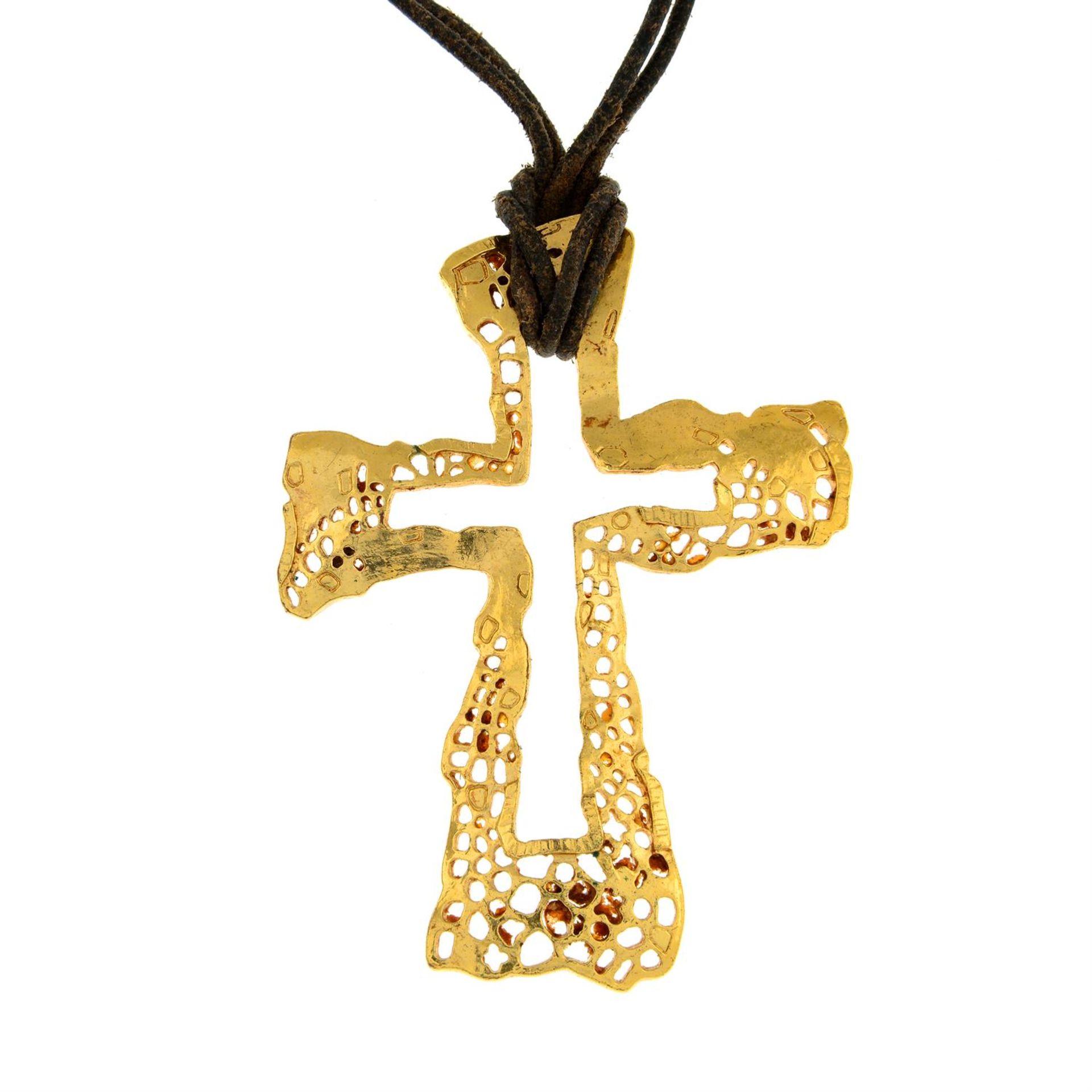 CHRISTIAN LACROIX - a cross pendant on leather cord.