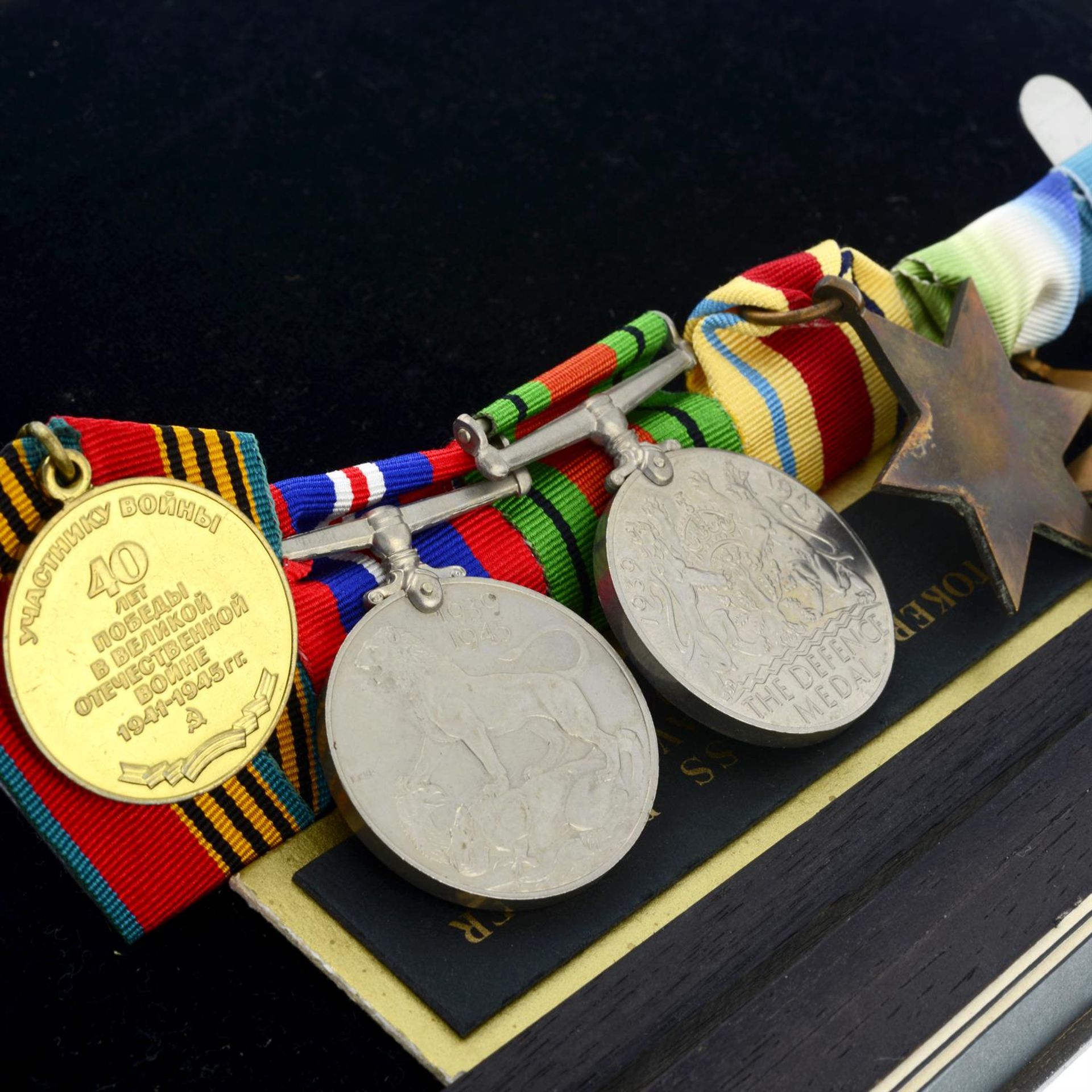 A group of five WWII medals, plus a Russian medal, all in glazed case. (6). - Image 3 of 3