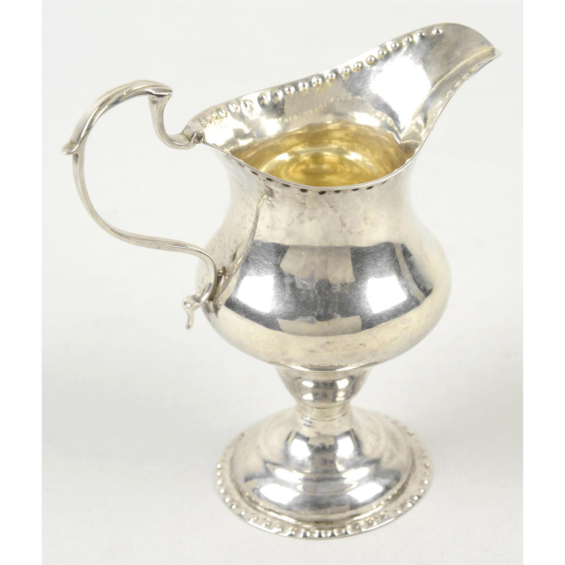 A George III silver pear shape cream jug on spread foot. - Image 2 of 3