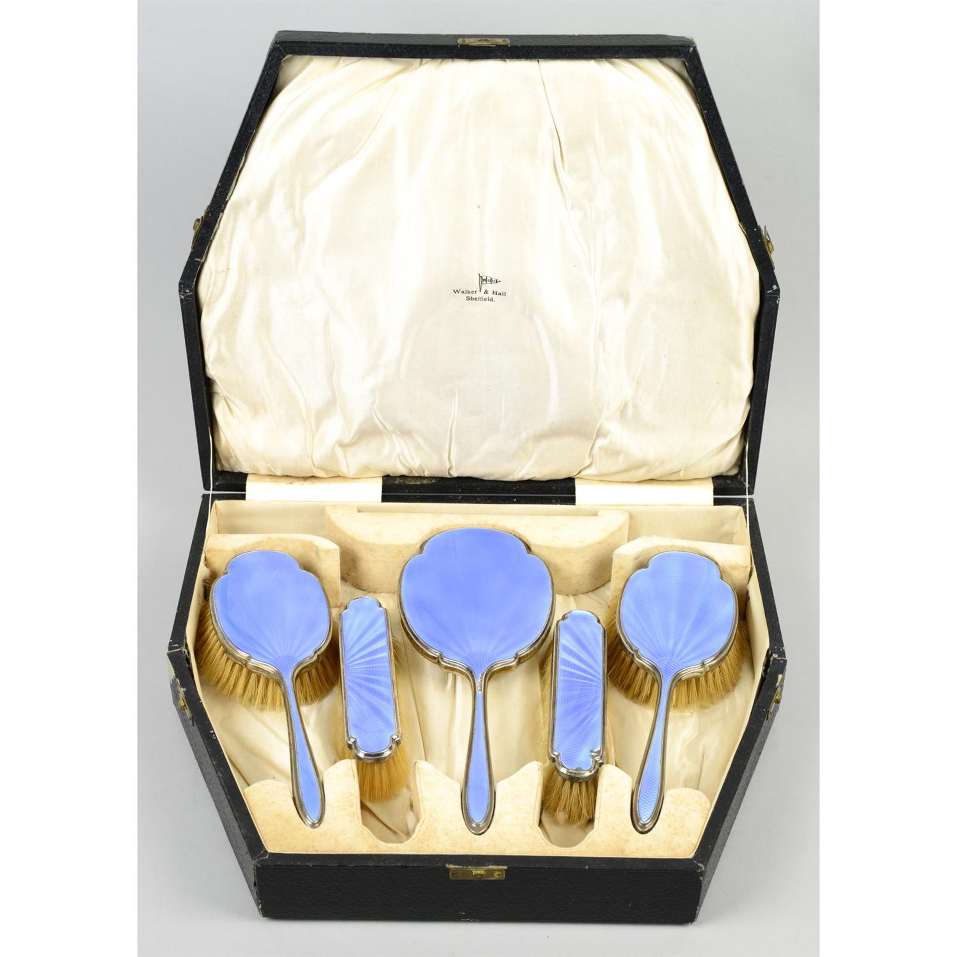 A cased 1930s' silver mounted & blue enamel part dressing table set.
