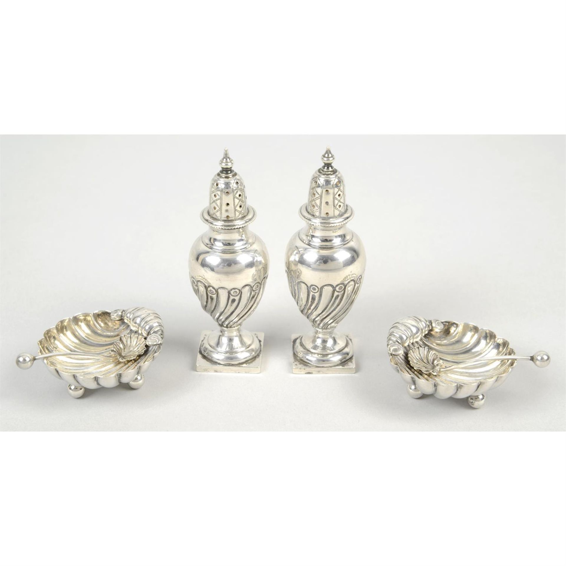 A pair of late Victorian pepper pots; together with a pair of shell salts with spoons.