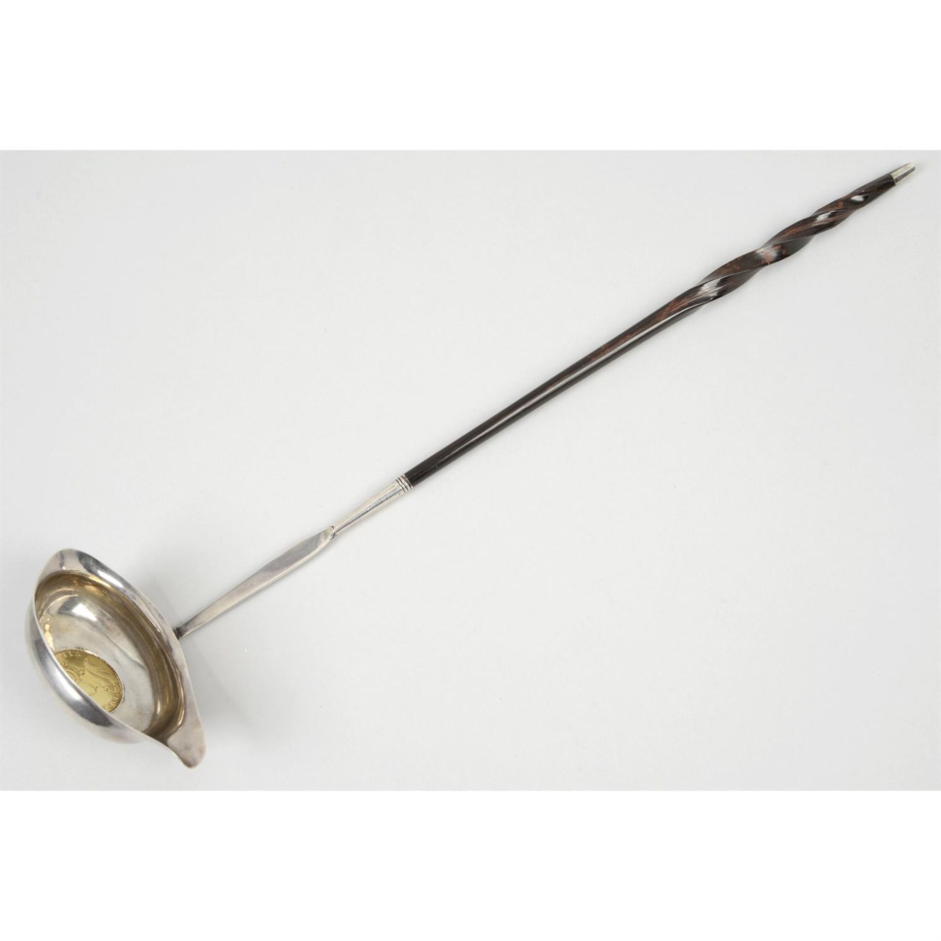 A George III silver punch ladle, inset with a Queen Anne Two-Guineas.