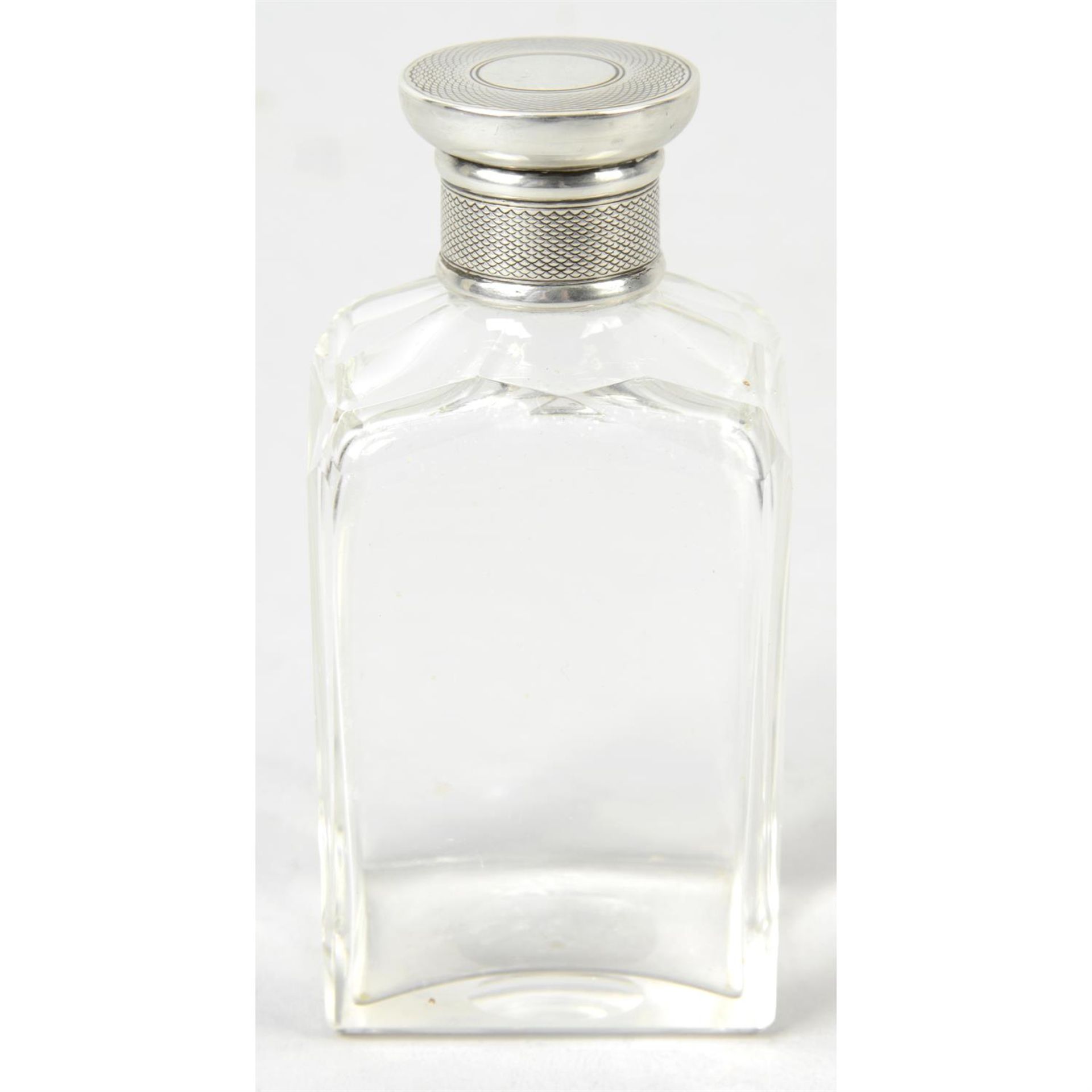 A gentleman's Edwardian clear glass rectangular scent bottle.