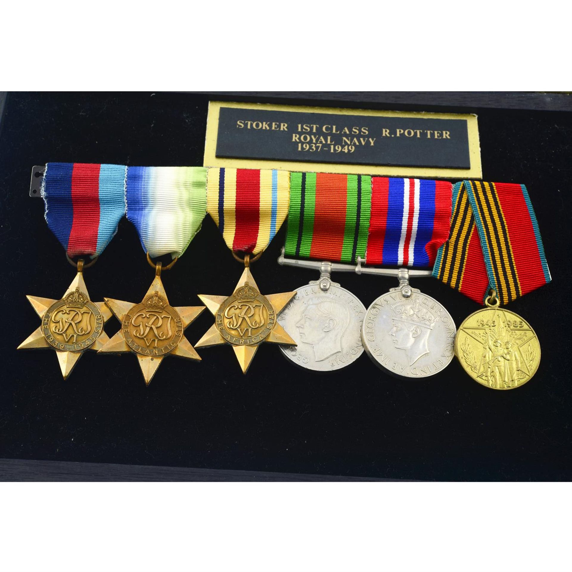 A group of five WWII medals, plus a Russian medal, all in glazed case. (6). - Image 2 of 3