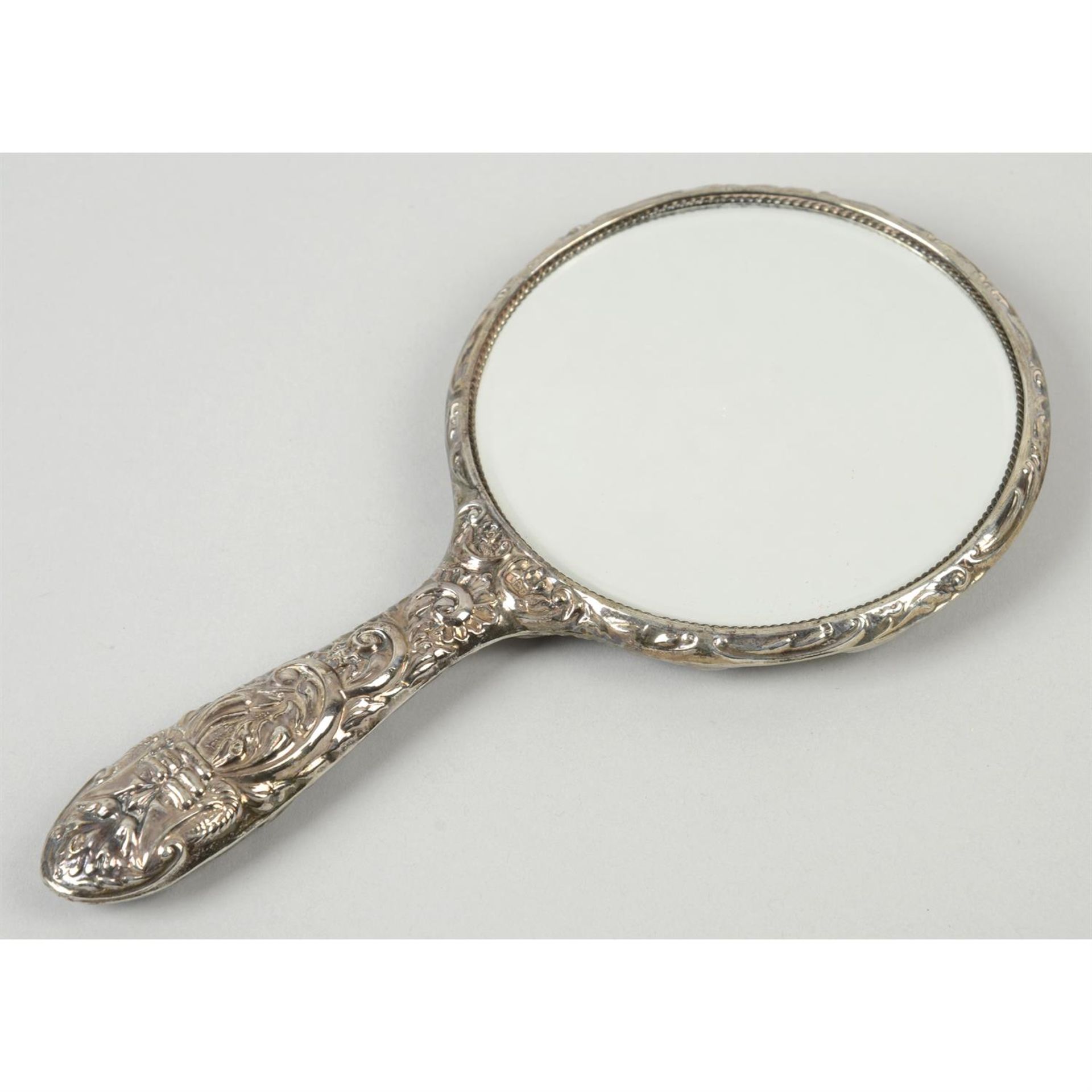 An embossed silver-handled hand-held mirror. - Image 2 of 3