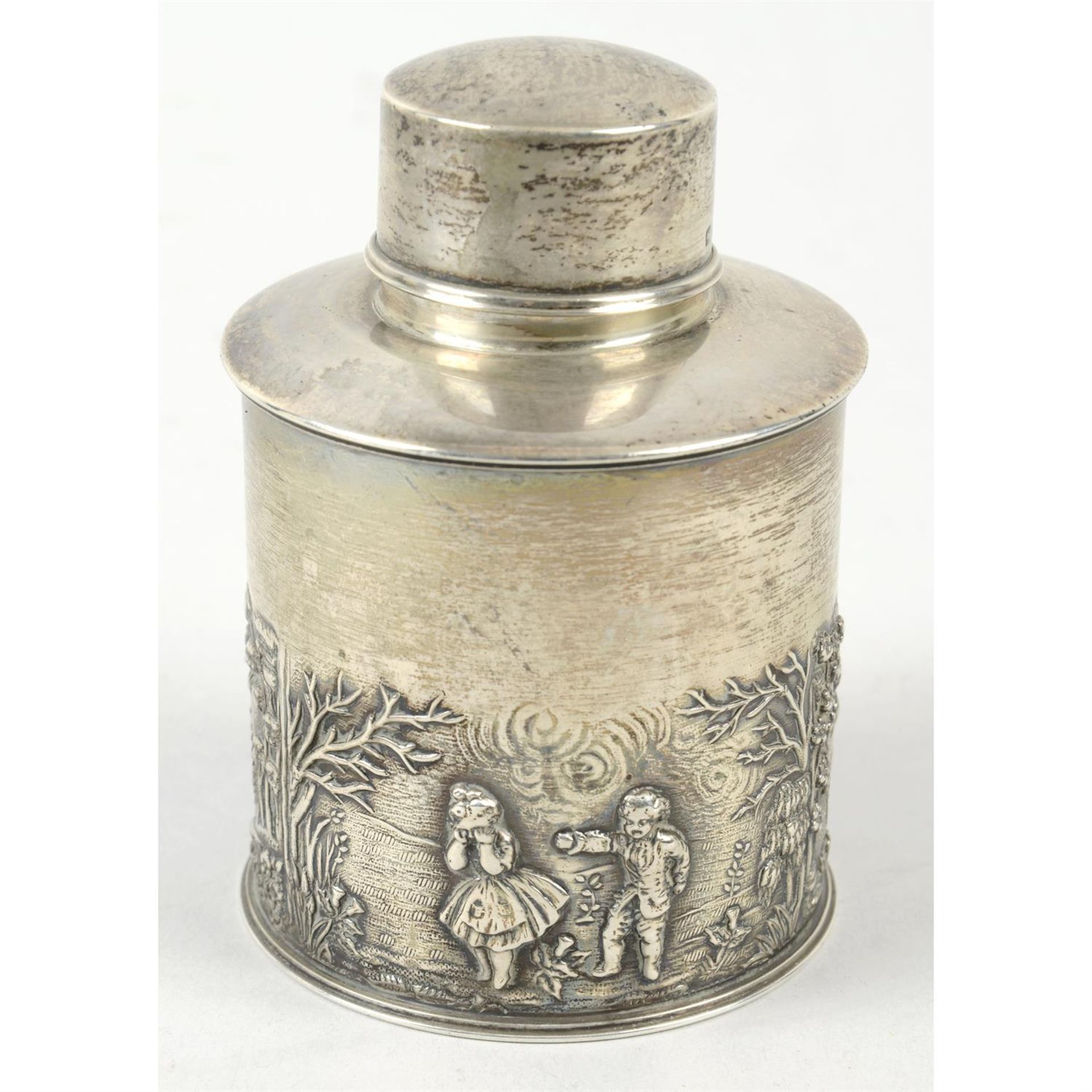 An Edwardian silver tea caddy with chased decoration.