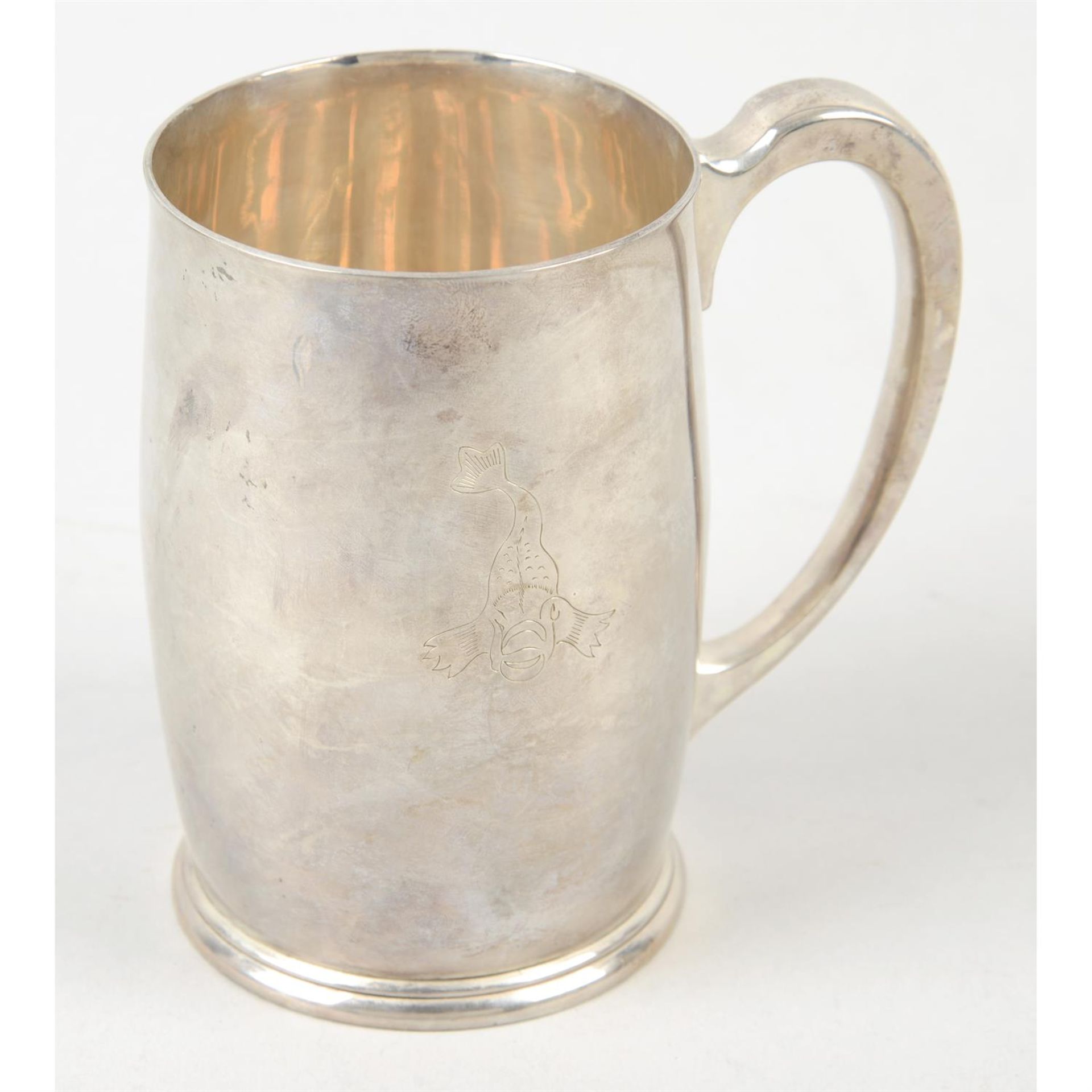 A mid-20th century silver pint mug with dolphin engraving, by Mappin & Webb.