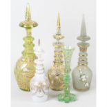 A large Victorian green glass decanter and stopper, together with four similar examples and a