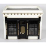 A small, painted wooden dolls house.