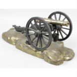 A late 19th century gilt bronze, wooden and cast metal library desk model of a field cannon.