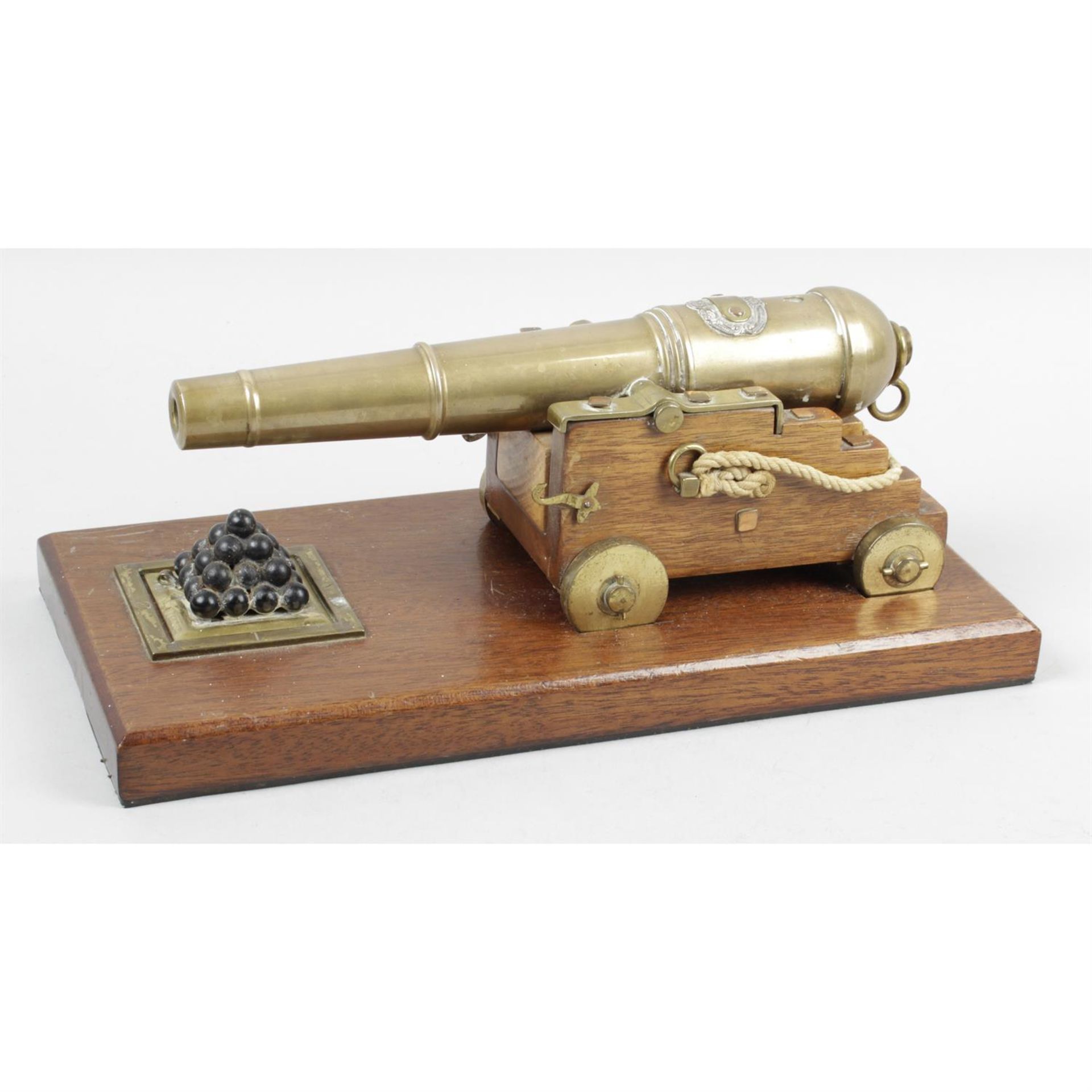 An early 20th century library desk model of a naval cannon.