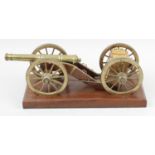 An early 20th century library desk model of a field cannon and companion limber.