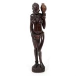 A large African carved hardwood figure modelled as a female.