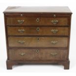 A gentleman’s early 19th century mahogany and walnut veneered chest of drawers.
