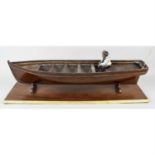 An early 20th century scratch built carved and stained wooden boat model.