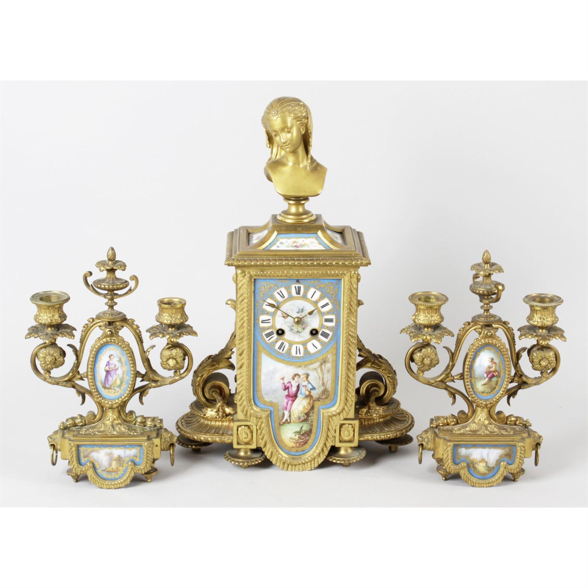 A 19th century French gilt bronze and porcelain panel inset clock garniture, together with a pair