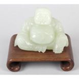 A carved green hardstone study of a Budai.