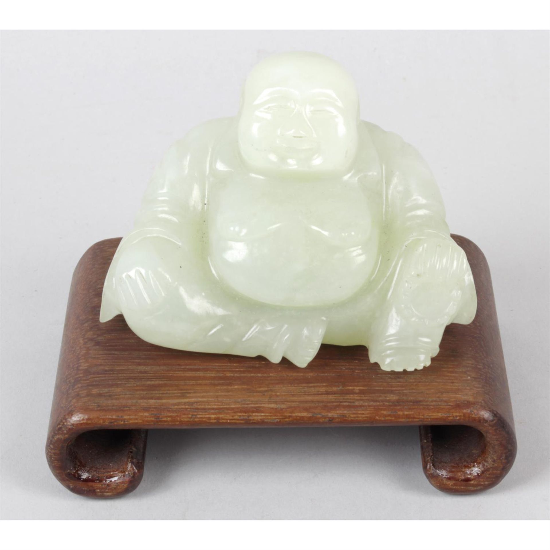 A carved green hardstone study of a Budai.