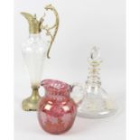 A claret jug with dragon decorated handle, together with a further clear, glass ships style