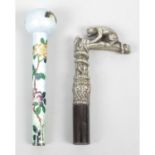 An early 20th century cloisonné walking cane or parasol handle, together with a cast metal walking