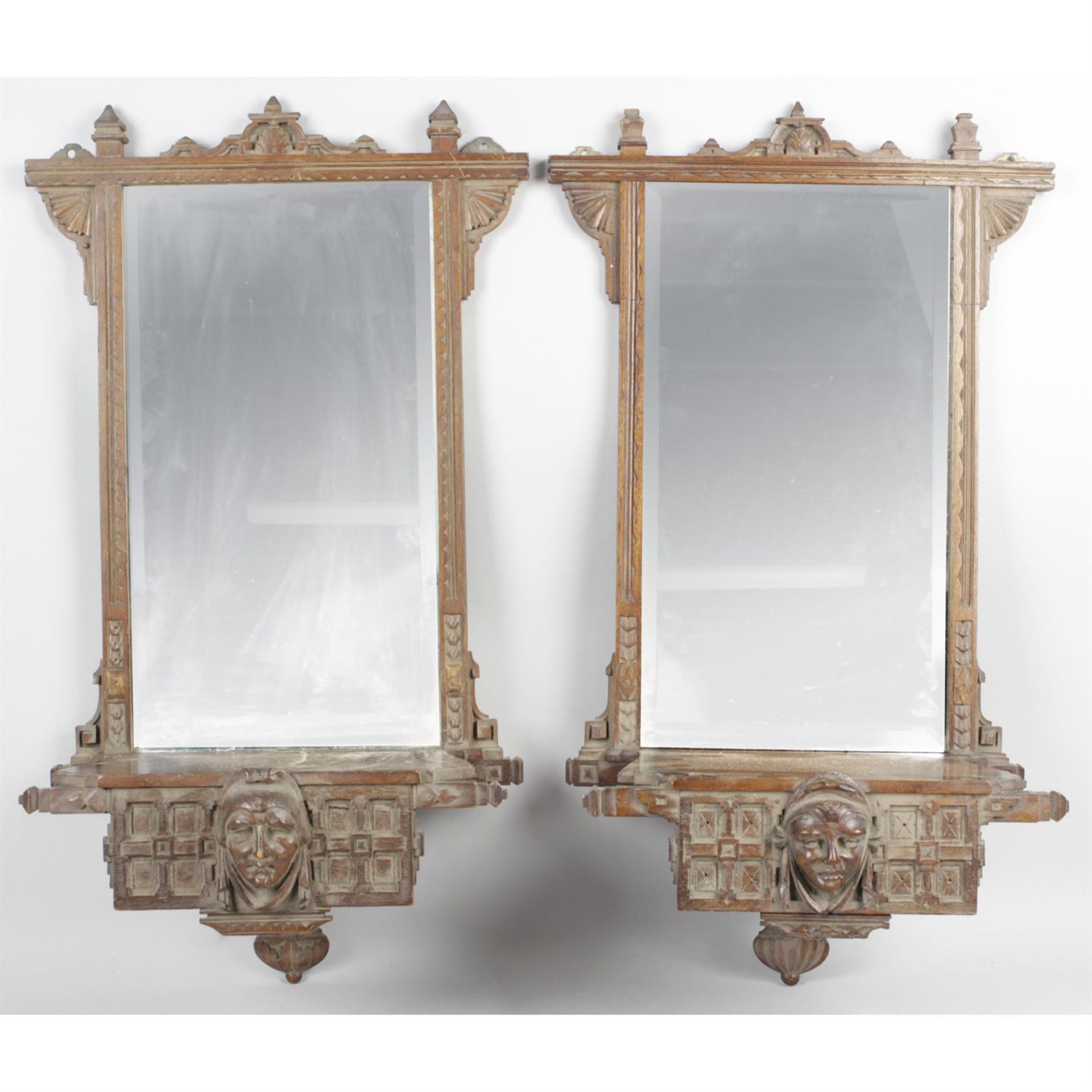 A pair of Arts & Crafts gothic design mahogany mirror backed wall brackets.
