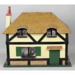 An early 20th century Lines Brothers for Gamages wooden dolls house.