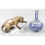 A Beswick study of a cougar, together with an Islamic pottery vase.