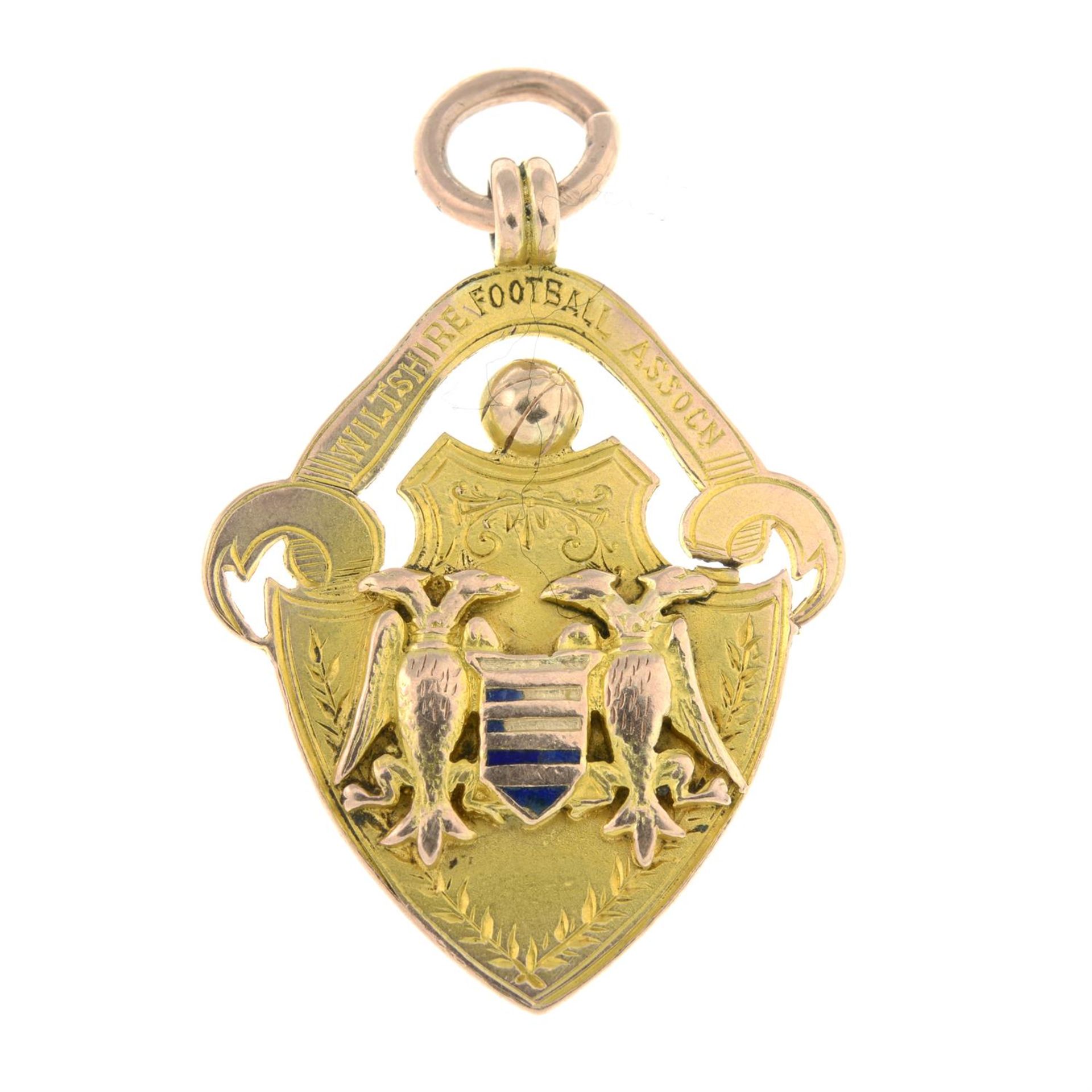 An early 20th century 9ct gold 'Wiltshire Football Association' enamel medallion pendant.