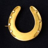 A late Victorian gold horseshoe brooch, with fitted Hancocks' & Co. case.
