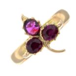 A ruby floral three-stone ring.