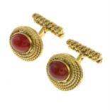 A pair of 1960s 18ct gold carnelian cufflinks, with rope-twist surround and hinged back bars.