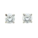 A pair of 18ct gold brilliant-cut diamond single-stone earrings.