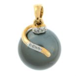 A cultured pearl pendant, with diamond highlights.