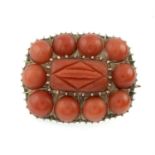 A 19th century 9ct gold carved coral brooch.