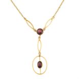 An early 20th century 9ct gold garnet pendant, with integral chain.