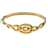 A Victorian 9ct gold knot hinged bangle.