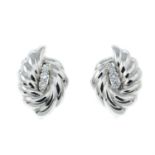 A pair of diamond accent clip earrings.