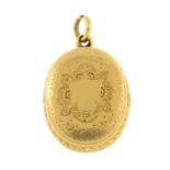 An Edwardian 15ct gold locket, with engraved floral motif.