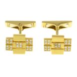 A pair of single-cut diamond geometric cufflinks.