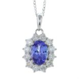 An 18ct gold tanzanite and diamond cluster pendant, with chain.