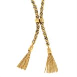 A 9ct gold twisted bi-colour necklace, with fixed panel clip and double tassels.