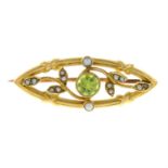 An Edwardian 15ct gold peridot and split pearl foliate brooch.