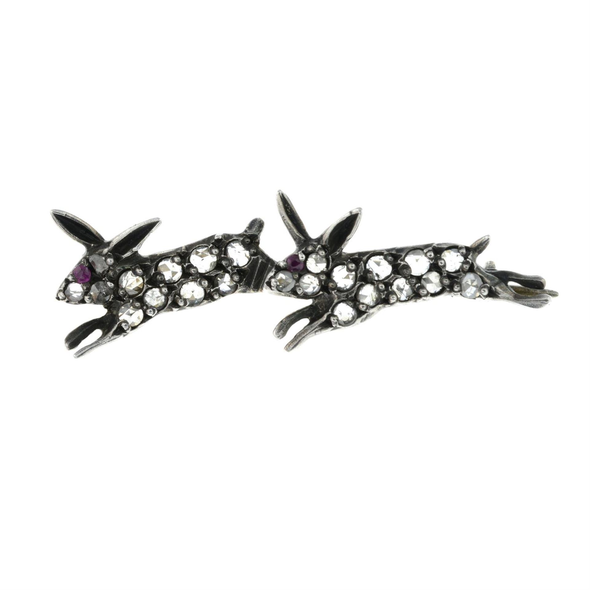 A late Victorian silver and gold rose-cut diamond and ruby leaping rabbits brooch.