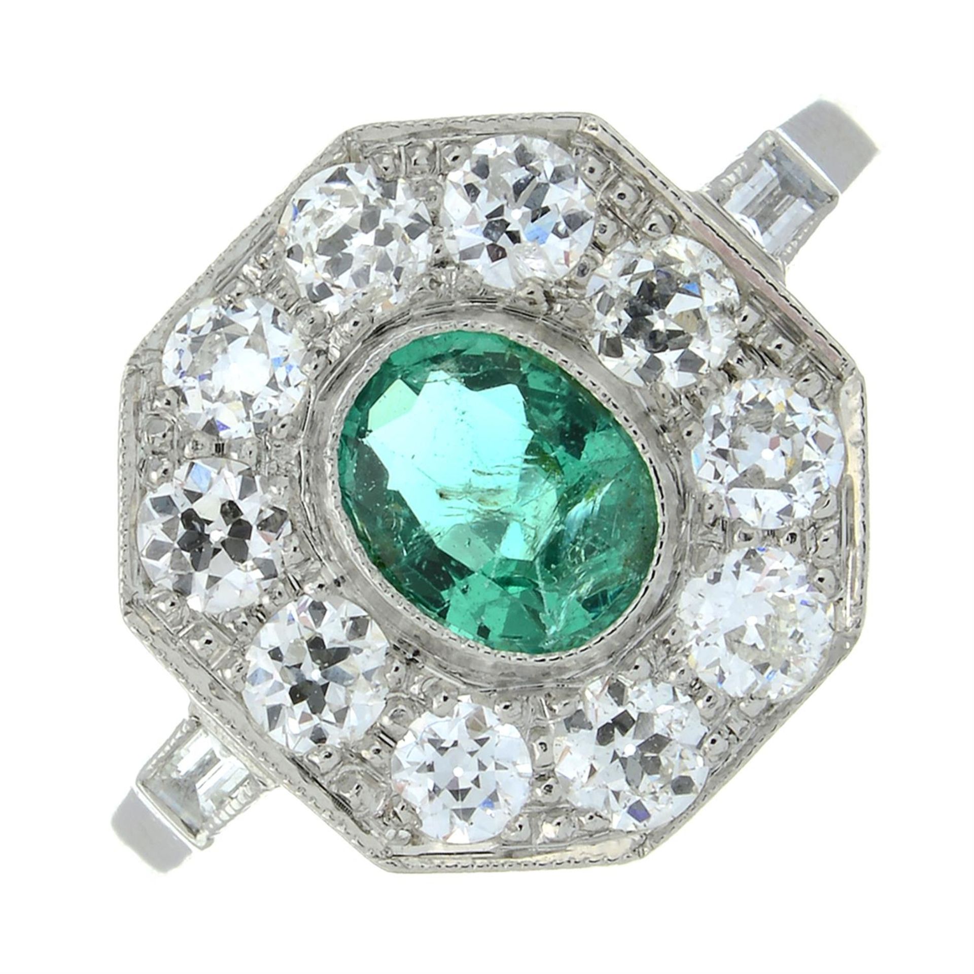 An emerald and brilliant-cut diamond octagonal-shape cluster ring.