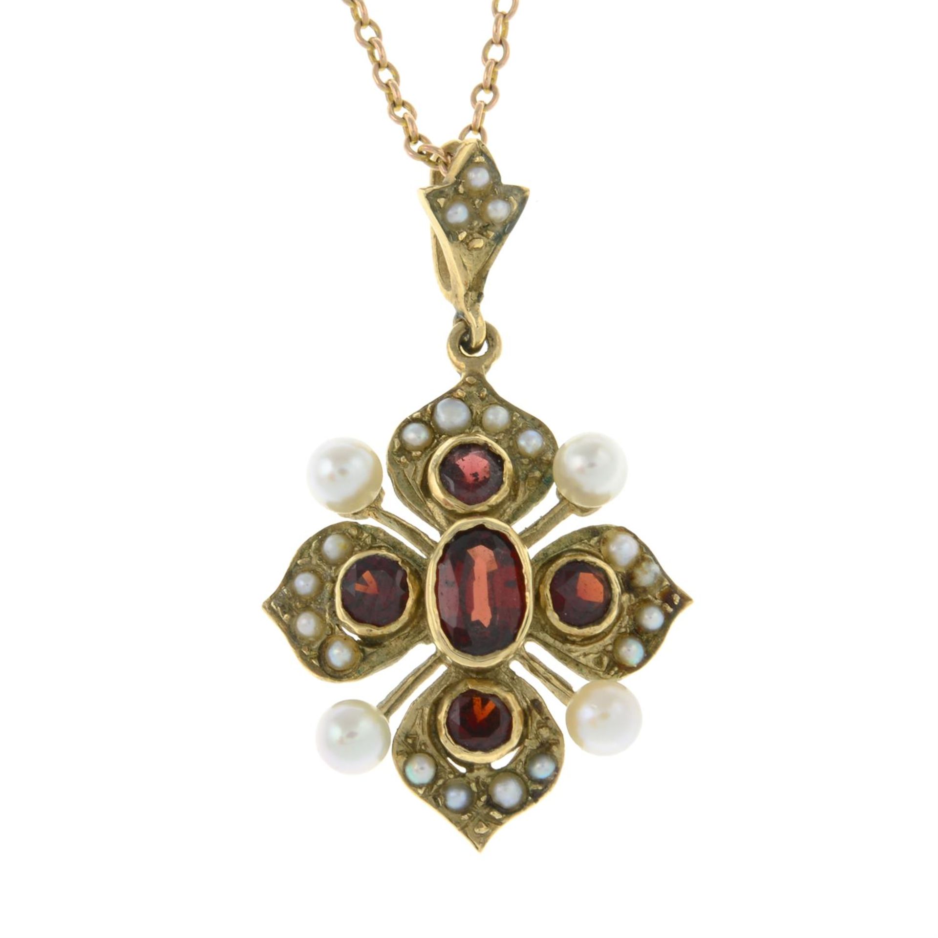 A 9ct gold garnet, seed pearl and split pearl stylised floral pendant, with chain.