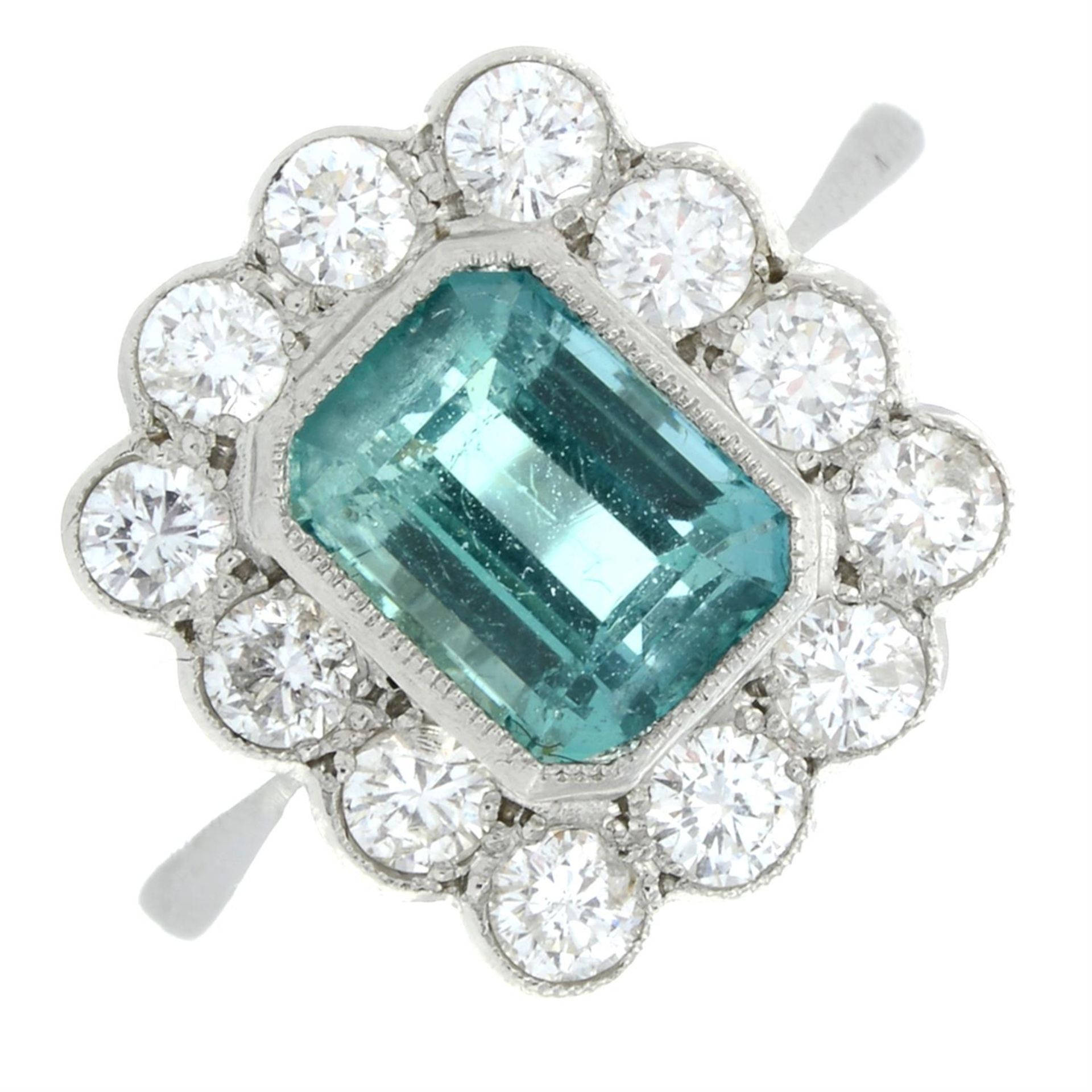 An emerald and brilliant-cut diamond cluster ring.