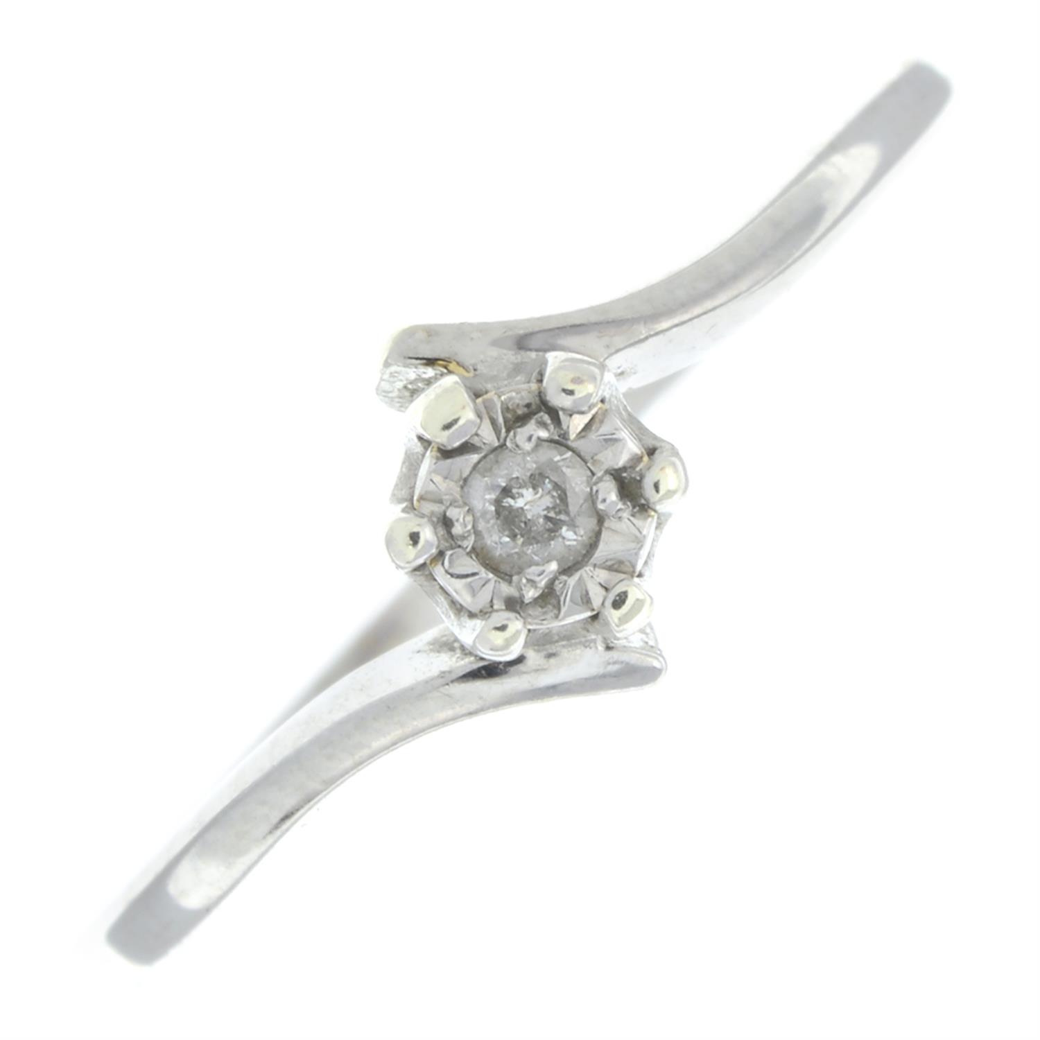 A 9ct gold brilliant-cut diamond single-stone crossover ring.